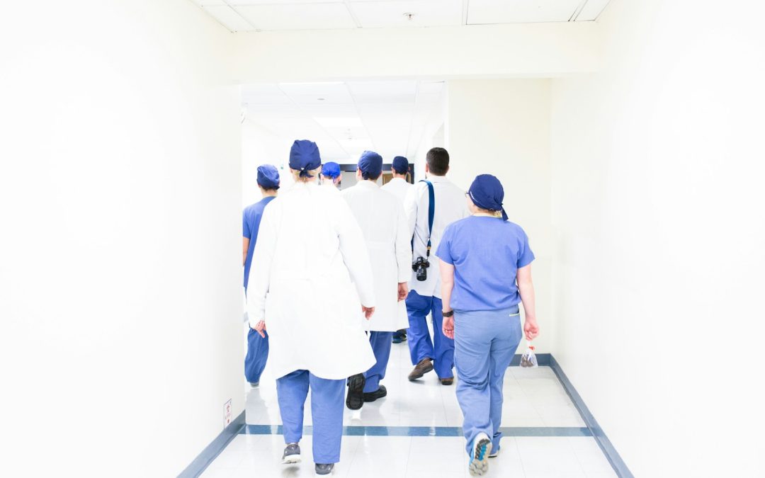 group of doctors walking on hospital hallway